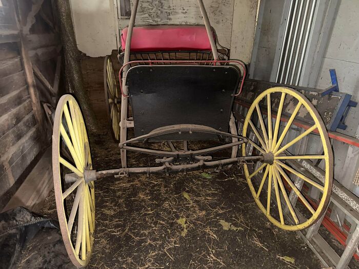 An old horse-drawn carriage with yellow wheels, a remarkable antique.