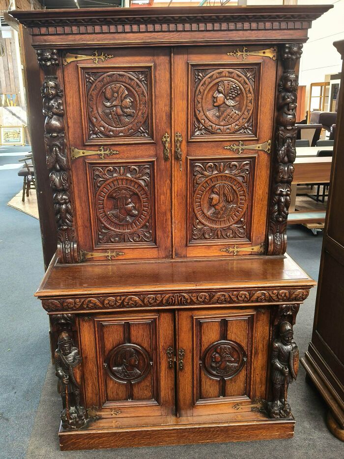 A remarkable antique wooden cabinet with intricate carvings and brass hardware, a special find.