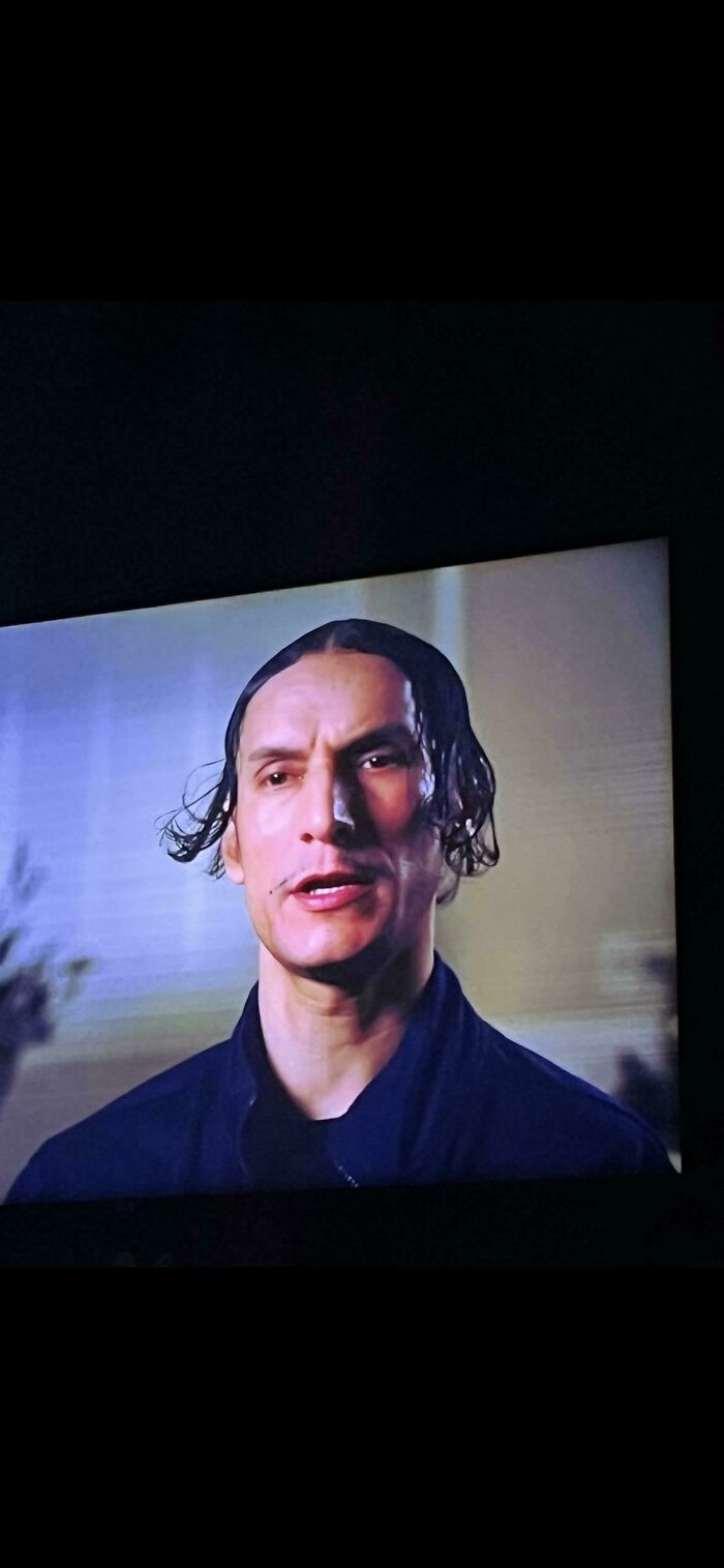 A man with a slicked-back, receding hairline and a thin mustache, exemplifying a bad hair day.
