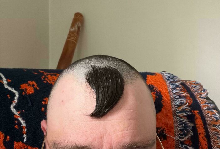 A person with a very bad hair day, sporting a buzz cut with a single patch of hair styled into a curl, going viral.
