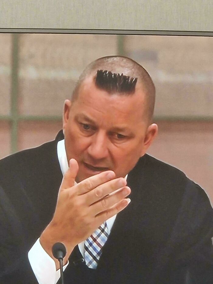 A man with a very short, spiky haircut that resembles a comb, having a bad hair day.