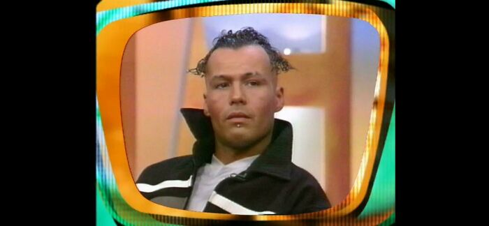 A man with an unusual hairstyle, small spikes of hair on top, having a bad hair day.