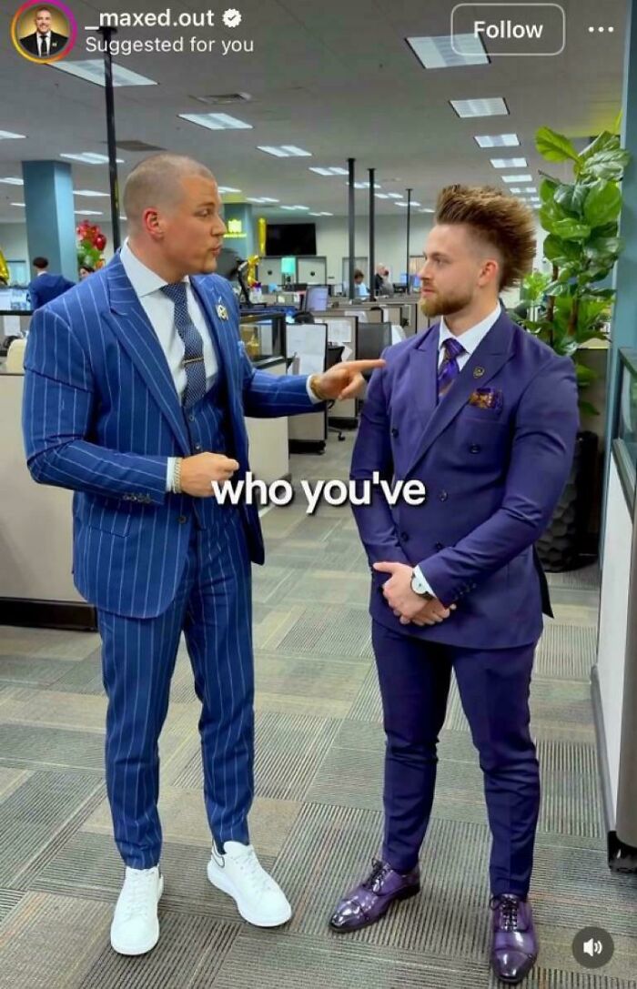 Two men in suits, one pointing at the other's distinctive spiky hairstyle, showcasing a unique bad hair day.