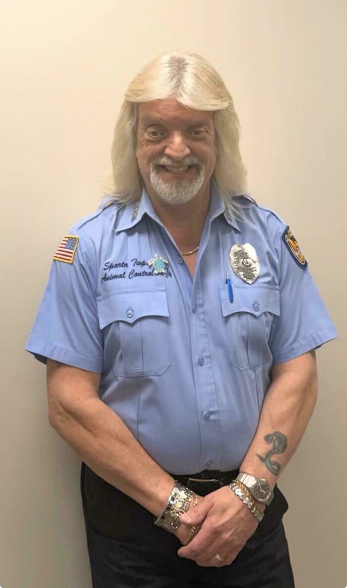 A man in an animal control uniform with a long blonde wig, representing a funny bad hair day.