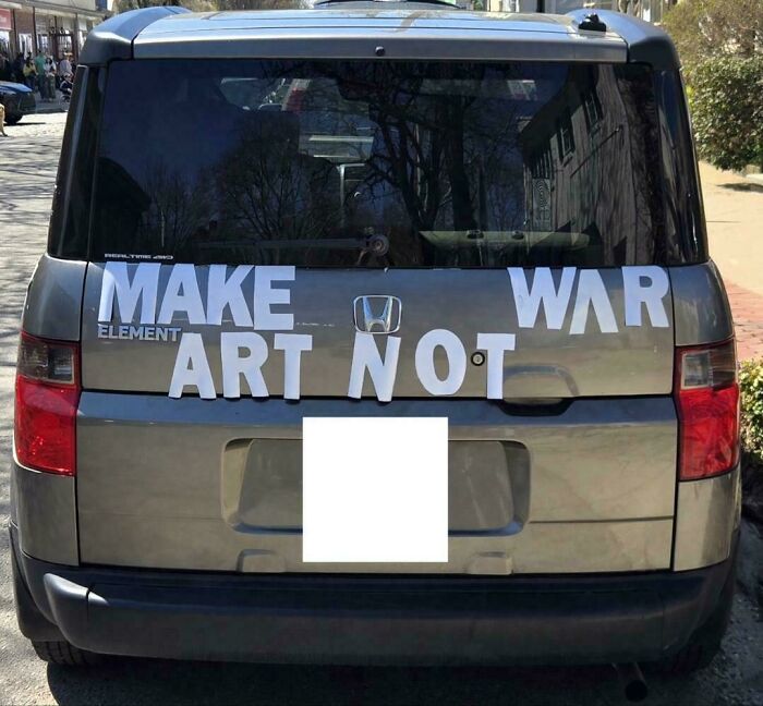 Hilariously confusing message from poor sign design: car with MAKE ART NOT WAR.