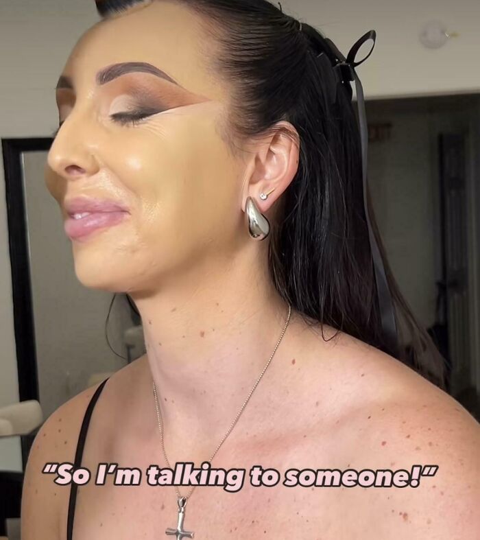 A woman with an overly contoured face and visible makeup lines, a beauty salon transformation gone wrong.