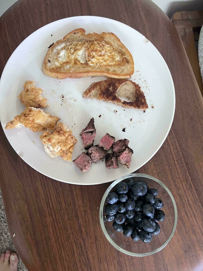 A plate of food, including blueberries, showing a wholesome meal prepared by a dad.
