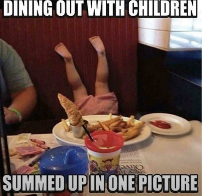 A funny meme showing a child upside down in a restaurant booth, summing up the wholesome and fun side of being a dad.