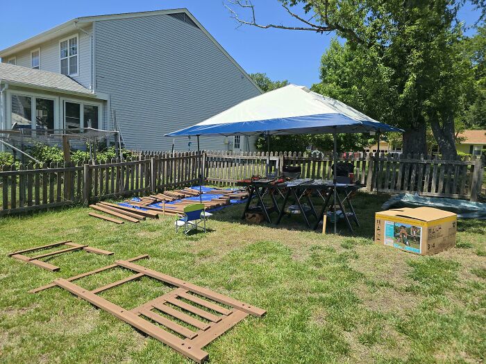 A backyard scene with a canopy and tools, indicating a project underway, embodying the wholesome side of being a dad.
