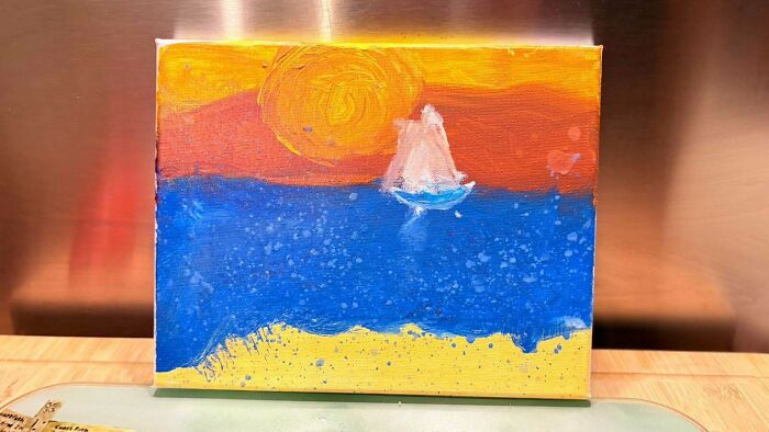 A child's painting of a sailboat on blue water under an orange sky, showing the fun side of being a dad.