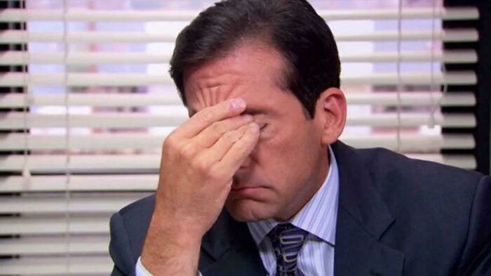 A man making a humorous facepalm expression, depicting a relatable moment of being a dad.