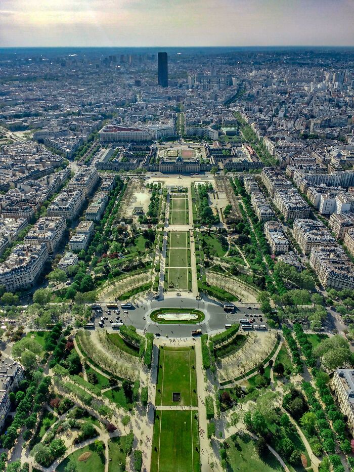 A stunning aerial shot of a meticulously designed park and cityscape, an interesting photo.
