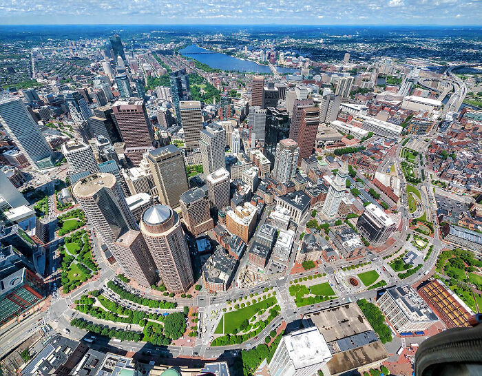 An aerial view of a bustling city skyline with tall buildings and green spaces, a truly interesting photo.