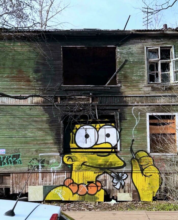 A Bart Simpson graffiti on a burnt building, an interesting photo showing urban art.