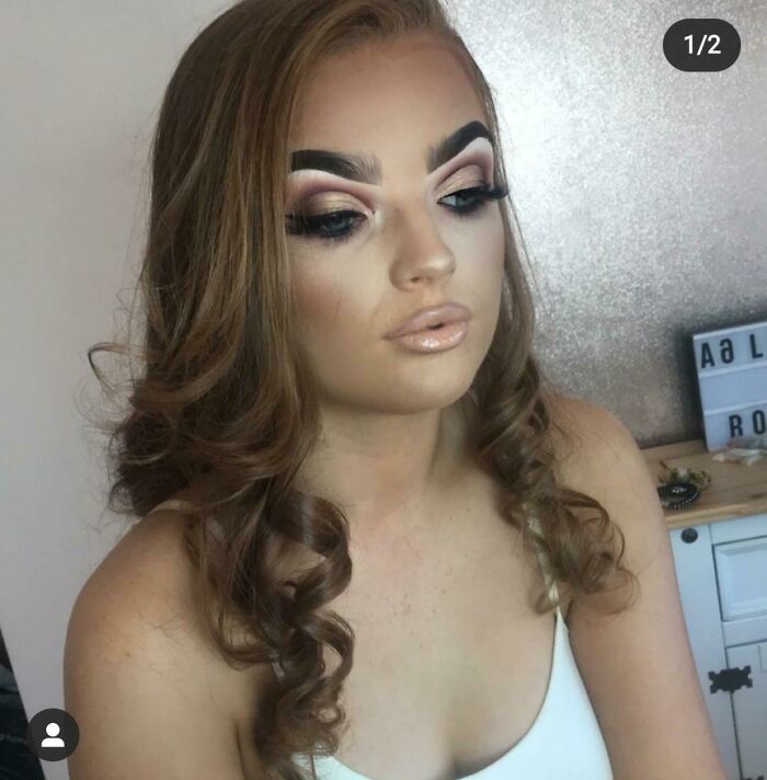 A young woman after a beauty salon visit, with overly done makeup, appearing significantly worse.