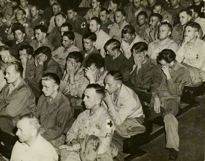 Historical photos: German POWs in a crowd, many covering their faces, reacting to a film about concentration camps.