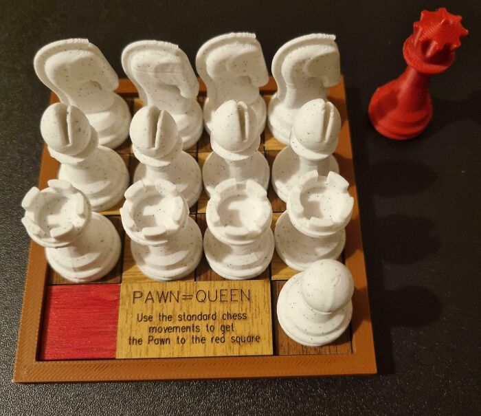 A chess brain puzzle, PAWN=QUEEN, with white chess pieces arranged on a small wooden board.
