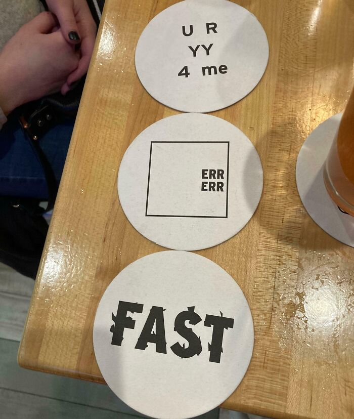 Three circular coasters with different brain puzzles on them, including letter and word play.