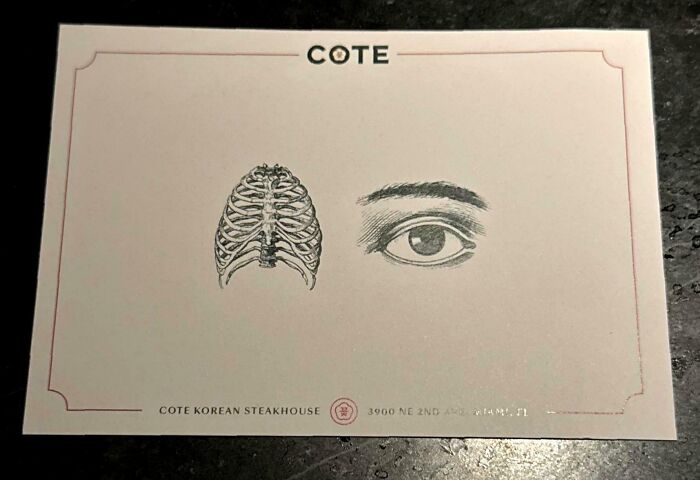 A COTE Korean Steakhouse card featuring a rib cage and an eye, an example of a brain puzzle.