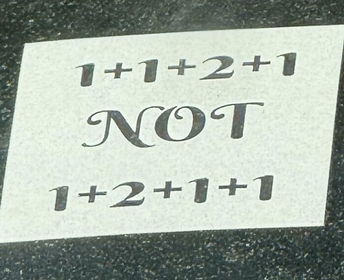 A white card with a math brain puzzle that reads 1+1+2+1 NOT 1+2+1+1.