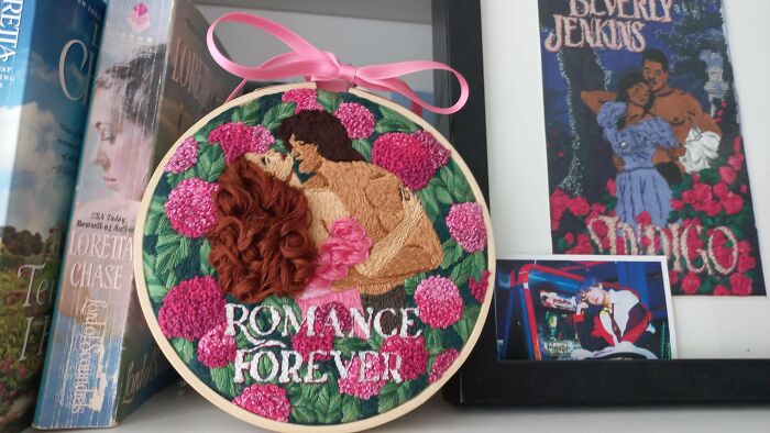 Romance novel cover style embroidery project with flowers and a couple