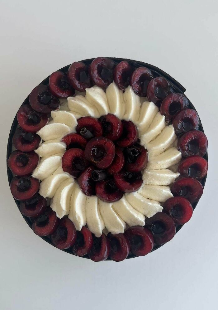 Amazing treats by bakers: A perfectly arranged cherry and cream tart, a delicious dessert.