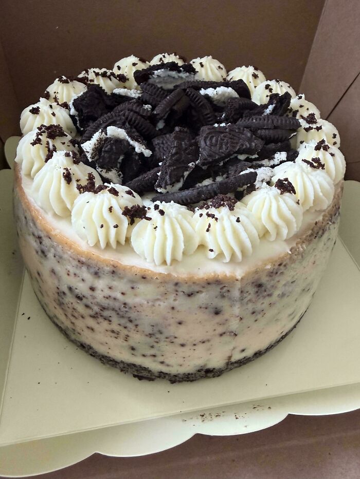A delicious cake from a talented baker, topped with generous Oreo cookies and creamy white frosting.