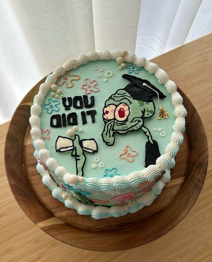 A creative baker's delicious cake featuring a Squidward graduation design, surrounded by delicate icing and vibrant colors.