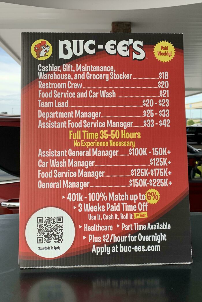 A Buc-ee's sign listing various job positions and their wages, including manager roles with high pay, for work.