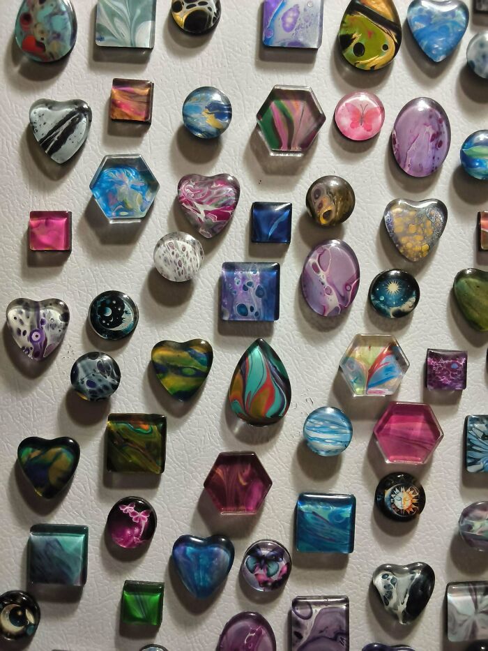 A close-up of numerous colorful handmade projects with swirled patterns, showcasing patience and creative talent.