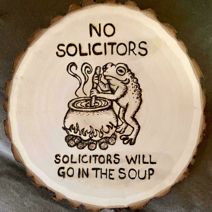 A handmade wooden sign with a frog cooking, a unique project showcasing talent and a little magic.