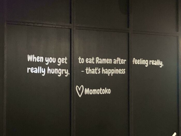 Ramen restaurant quote about happiness and hunger on wall