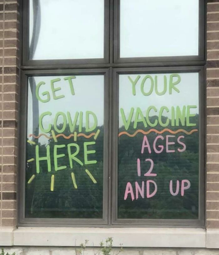 Window sign advertising COVID vaccine for ages 12 and up