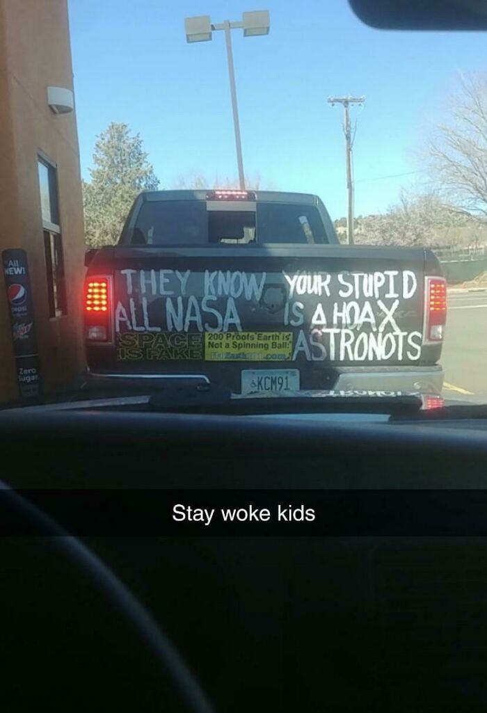 Pickup truck with funny conspiracy theory about NASA and astronauts on the tailgate