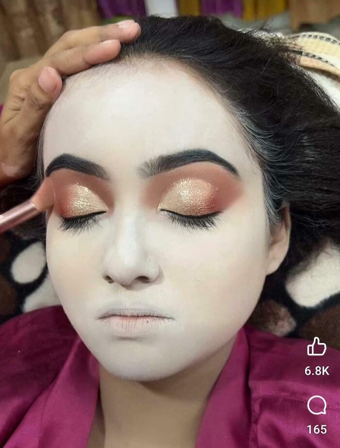 A person receiving a beauty salon treatment for dramatic eye makeup, looking significantly worse than expected.