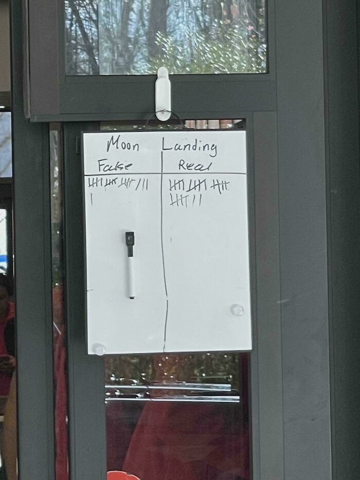 Whiteboard tally comparing moon landing false versus real votes