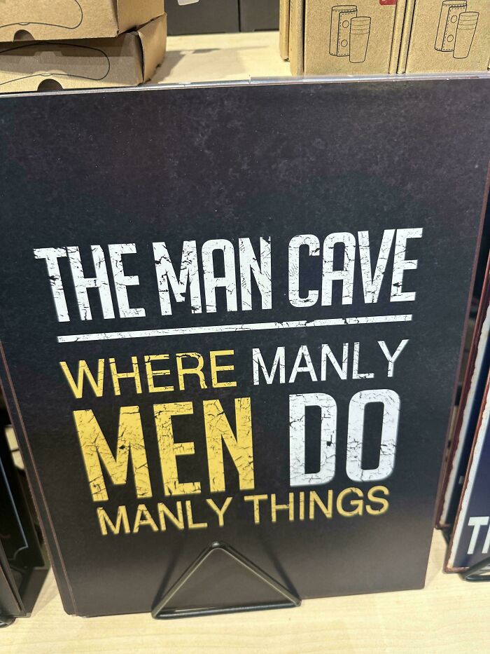Man cave sign with bold text about manly men doing manly things