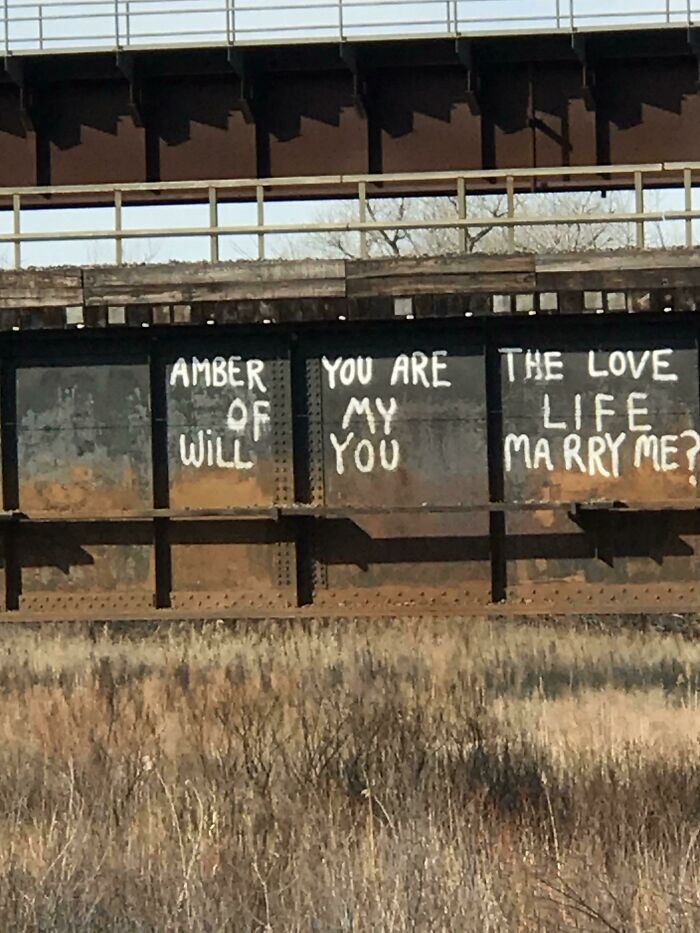 Railroad graffiti proclaiming love and marriage proposal to Amber