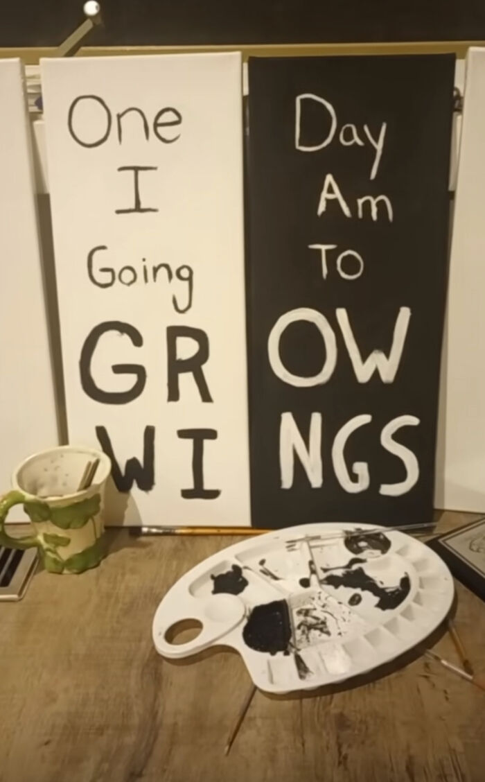 Humorous painting with a jumbled growth message and art supplies