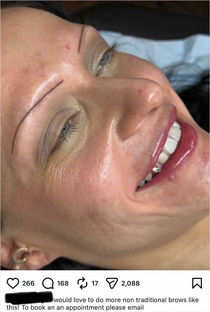 A woman with thin, drawn-on eyebrows, smiling uncomfortably after a beauty salon experience.