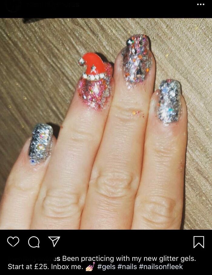 A hand with glitter gel nails, one featuring a small red Santa hat, showing an example of a beauty salon result.