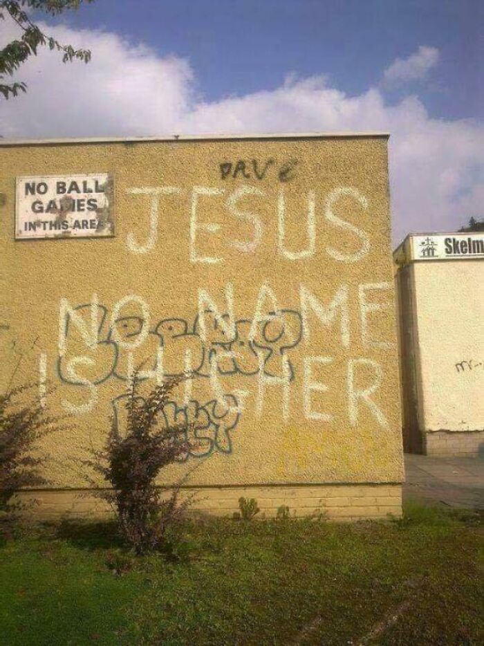 Graffiti on wall says no ball games while sign also states no ball games irony humor