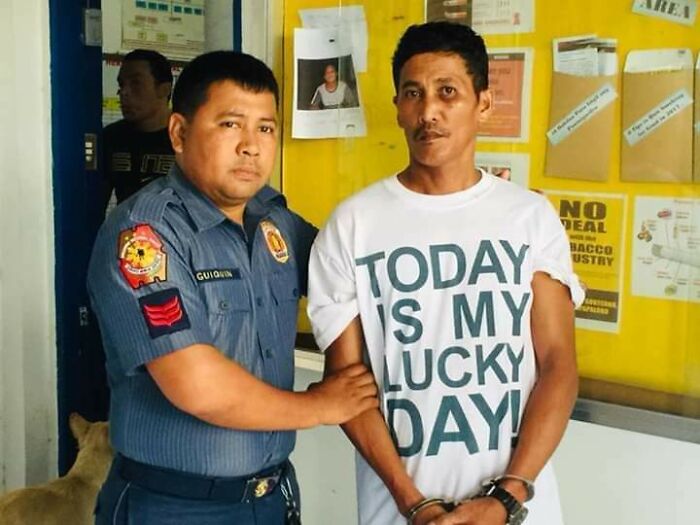 Man in handcuffs wearing irony tshirt saying today is my lucky day