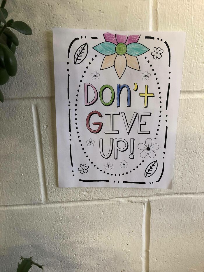 Colorful don’t give up sign ironically missing apostrophe on wall