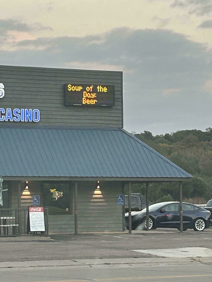 Building sign humorously displaying soup of the day as beer