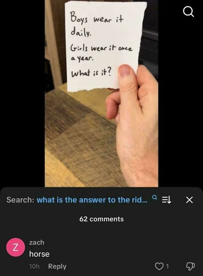 Hand holding a note with a riddle about what boys wear daily and girls wear once a year