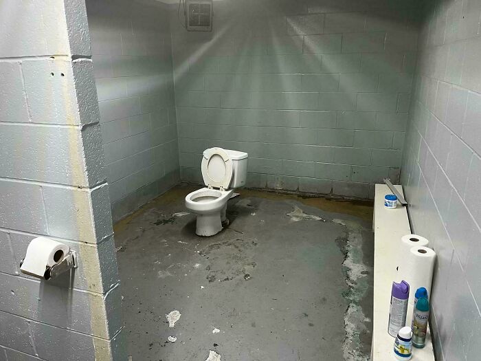 Dilapidated bathroom with a poorly maintained toilet showing design fail