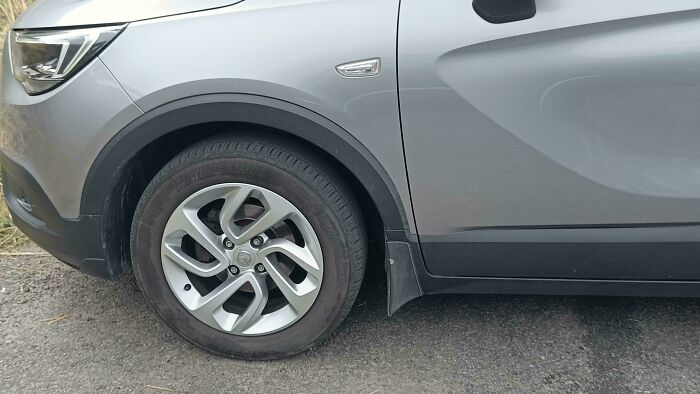 Car with a flat tire showing a major design fail in automotive design