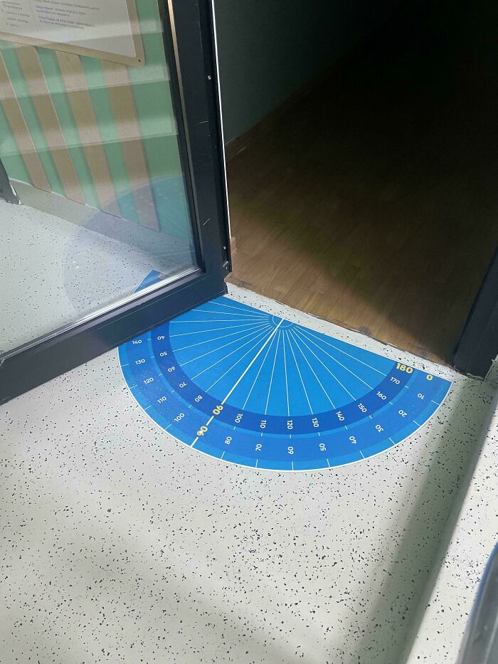 Protractor floor decal partially covered by open door creating design fail