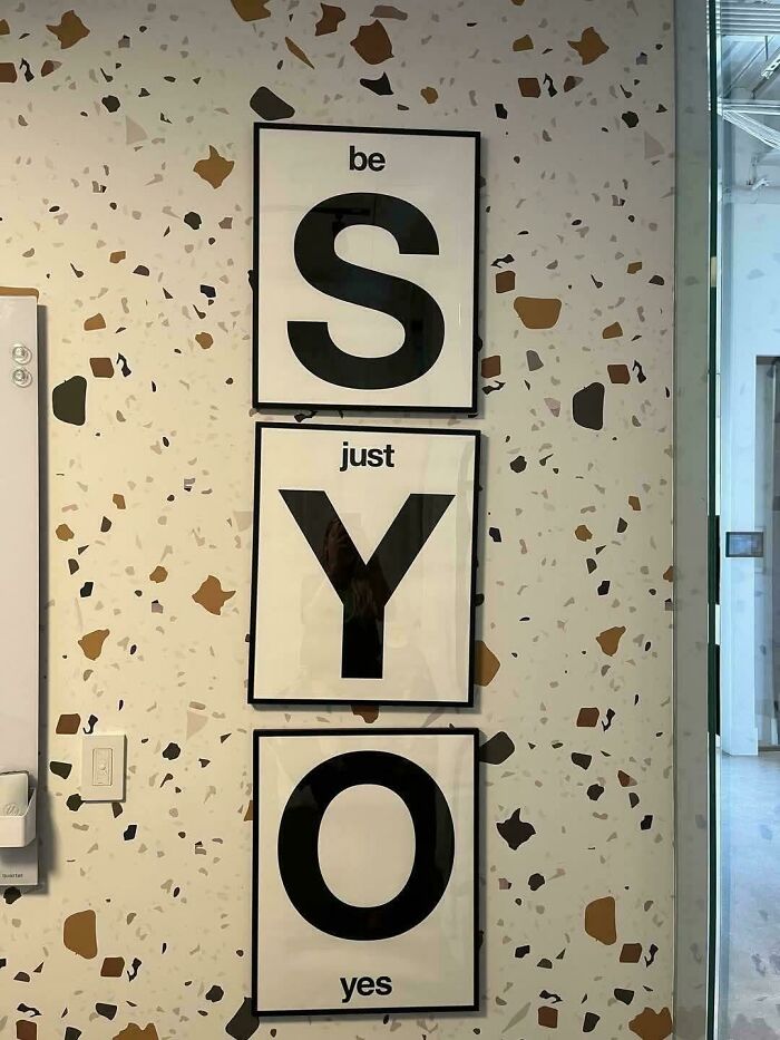 Wall art layout with framed letters spelling SYO creating odd design fail